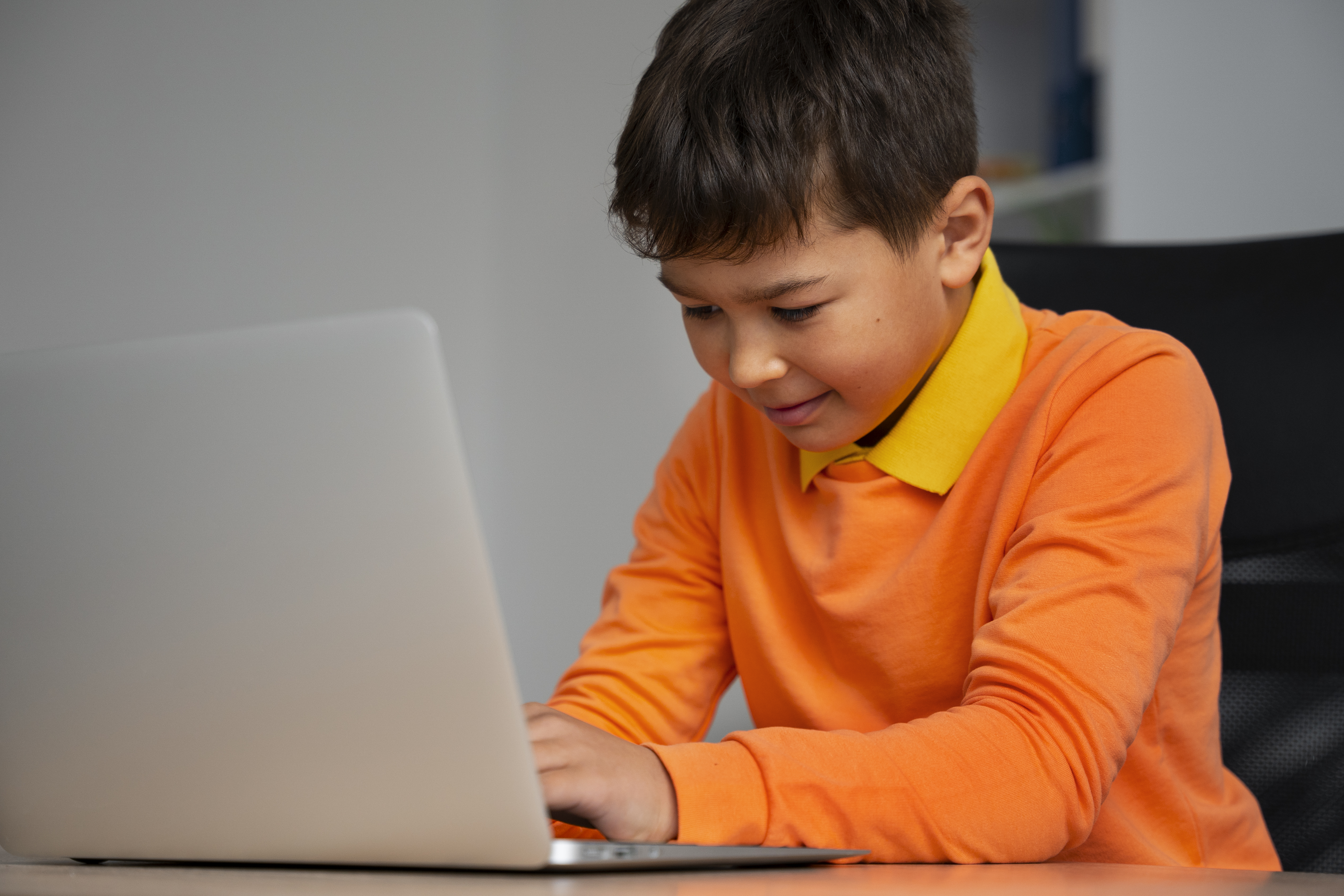 Kids coding on computers